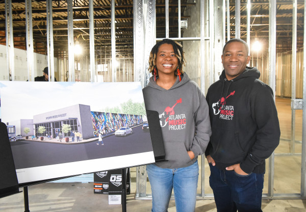 Aisha Moody, co-founder and director of AMP choirs and Dantes Rameau, co-founder and executive director AMP, pose in the future AMP Center for Performance & Education after the lease signing. 
